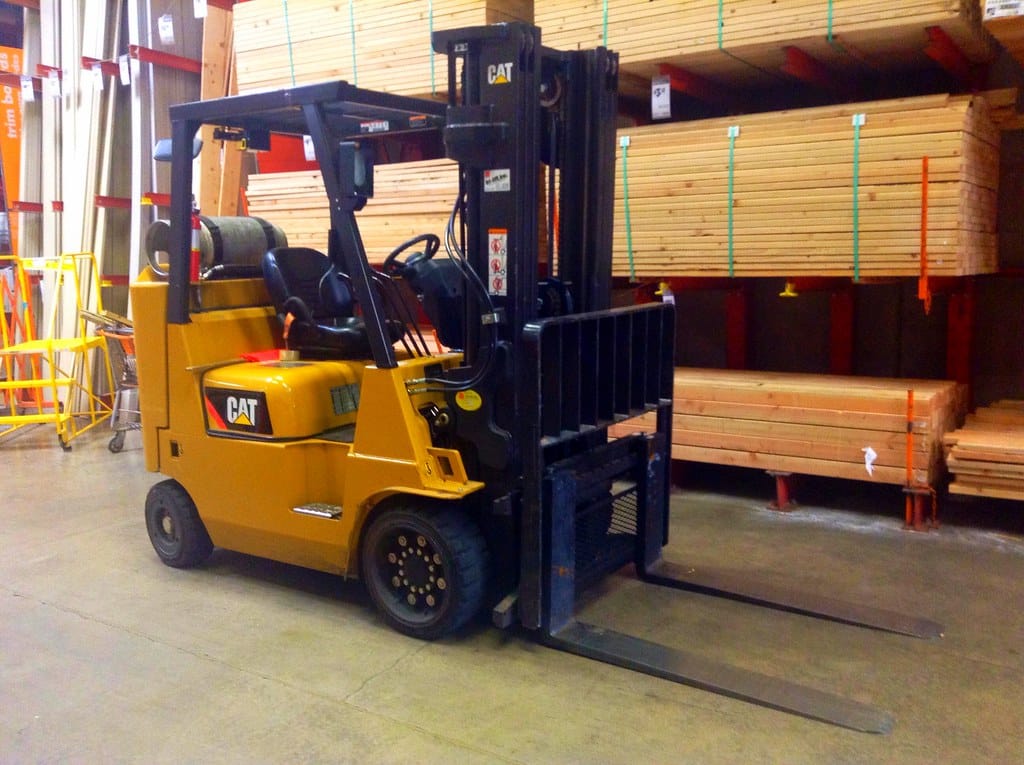 Counterbalance forklift parked in a lumber warehouse
