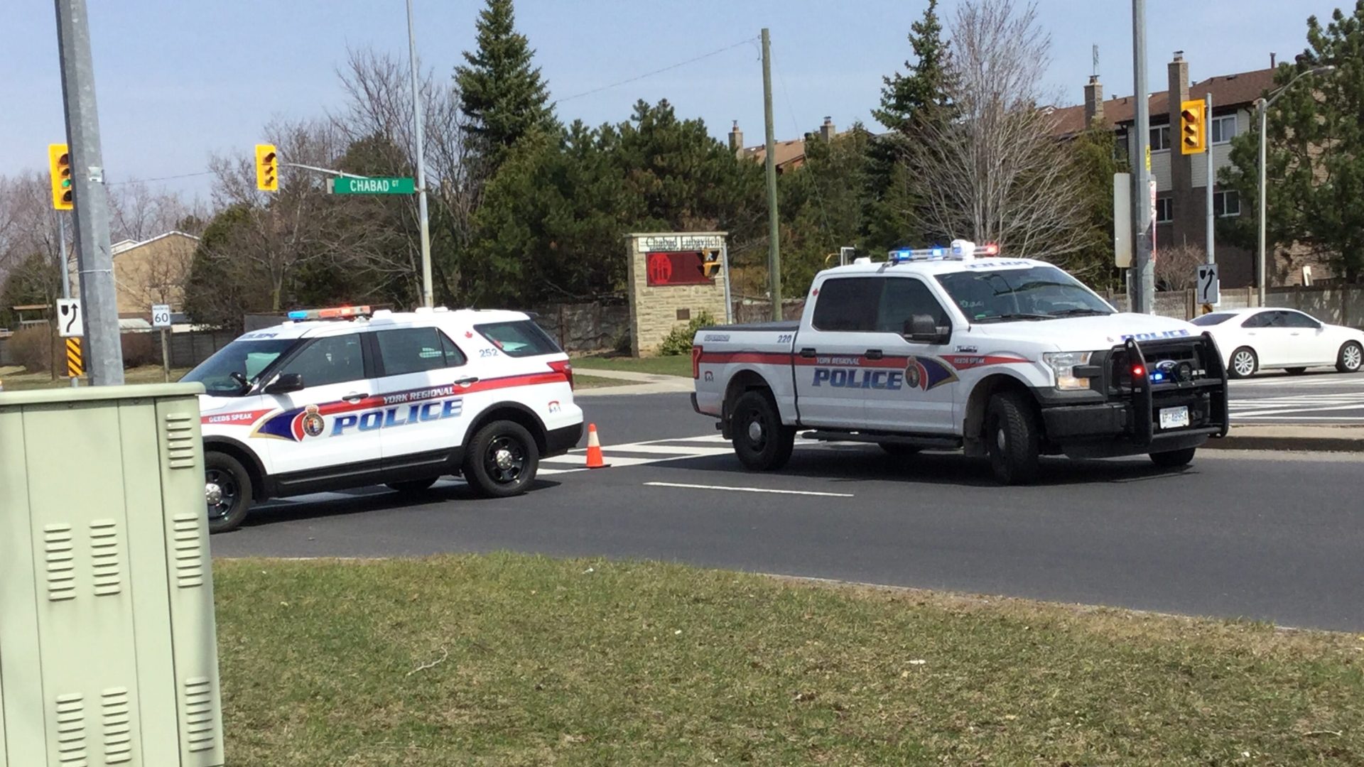 Police vehicles at the scene of a traffic collision on a city street