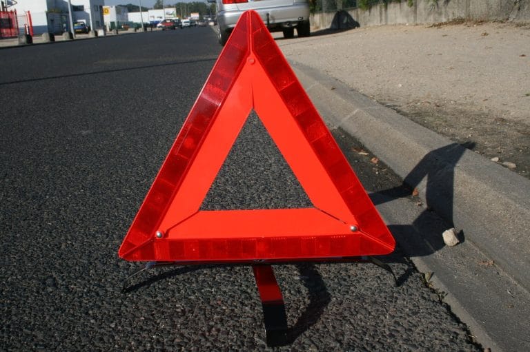 Reflective warning triangle standing on asphalt